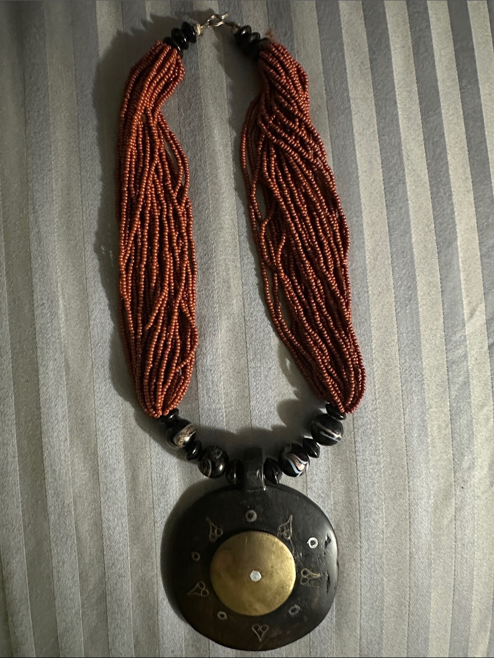 Handcrafted Multi-Strand Brown Bead Necklace with Brass Pendant